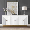 White 3-door sideboard with decorative items against a dark paneled wall.