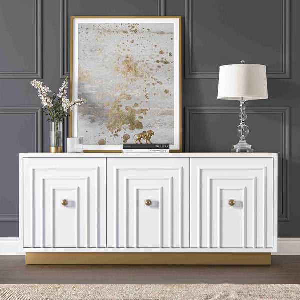 White 3-door sideboard with decorative items against a dark paneled wall.