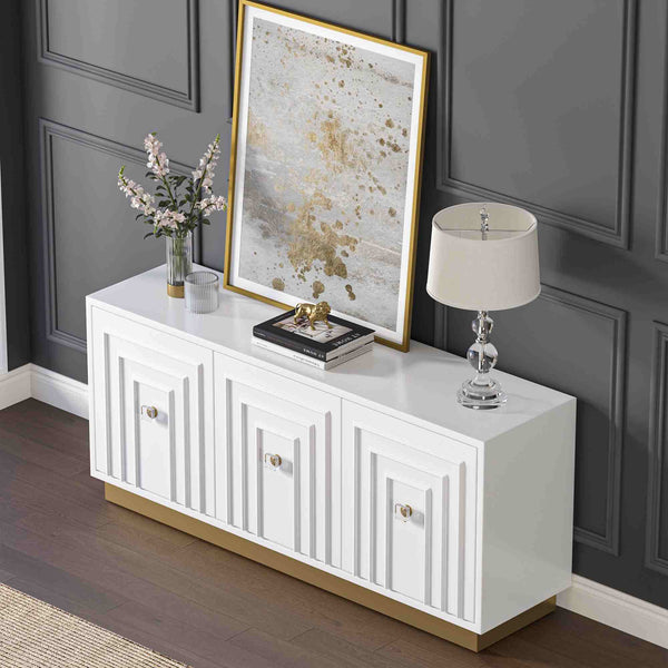 White 3-door sideboard with decorative items against a dark paneled wall