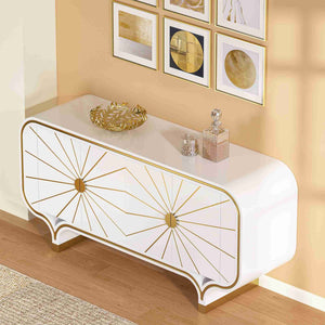 White 4-door buffet with gold accents in a room with framed art on the wall.