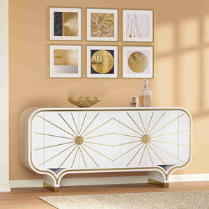 Decorative 4-door buffet with gold accents against a beige wall with framed art.